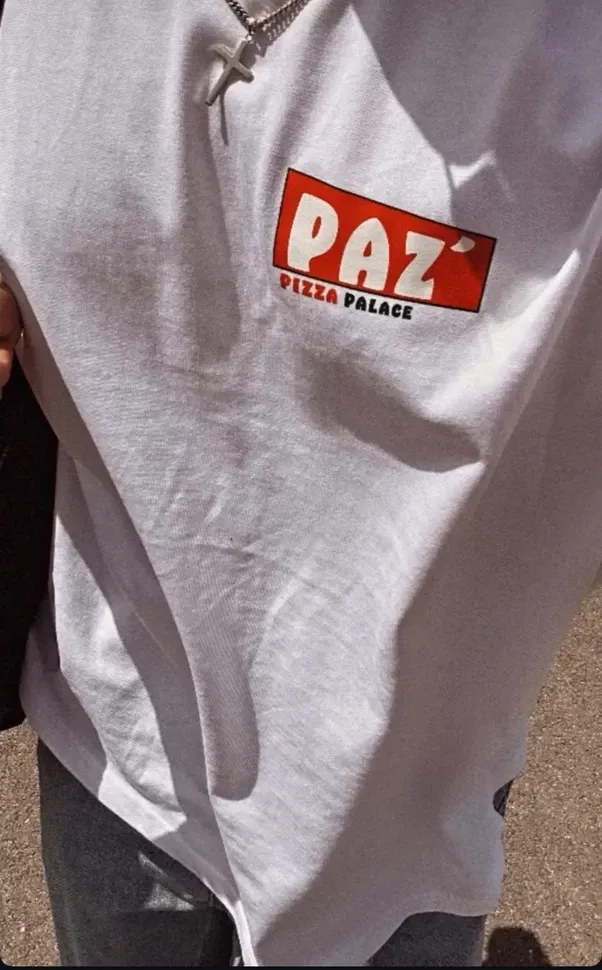 A friend wearing the Paz Pizza Palace tee