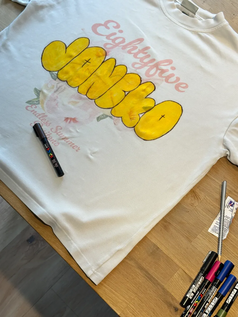 Hand-painted lettering on a tee